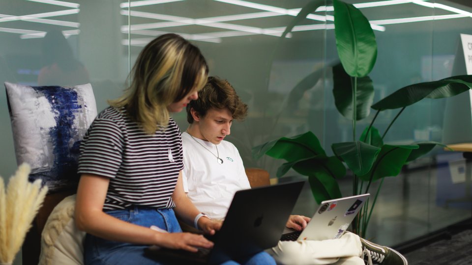 Two Roblox employees collaborating together on a project